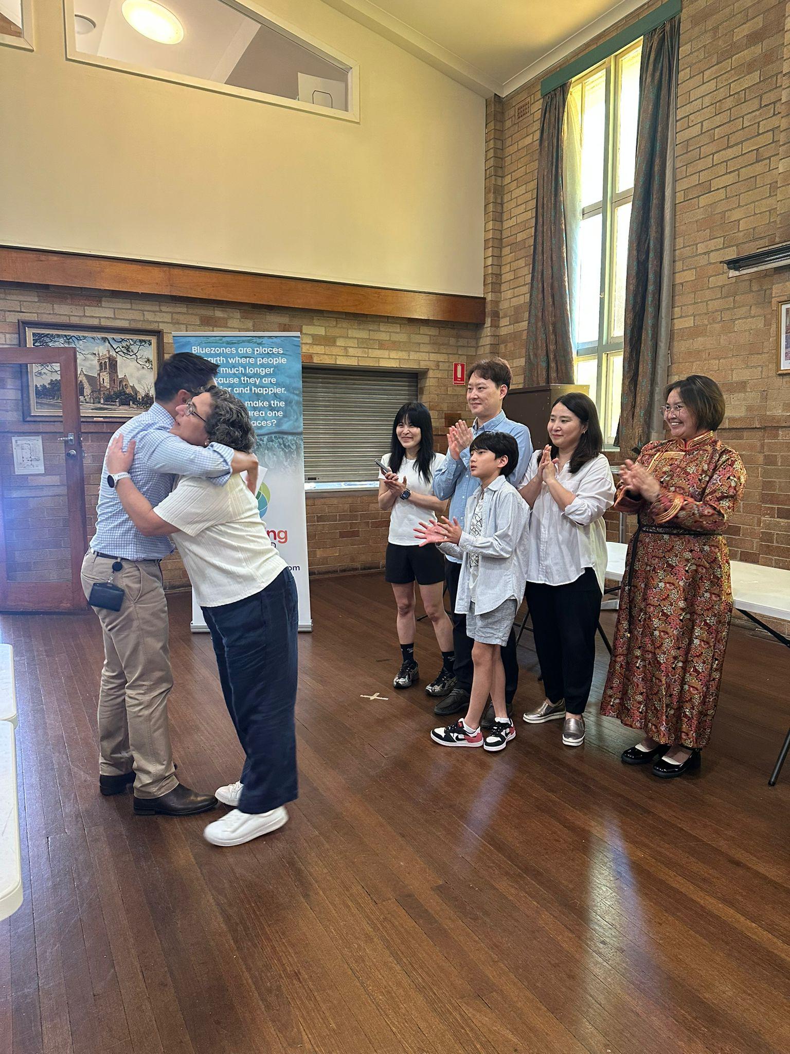 SMULC member recognised at a Strathfield MP community service award ceremony, with members and families applauding