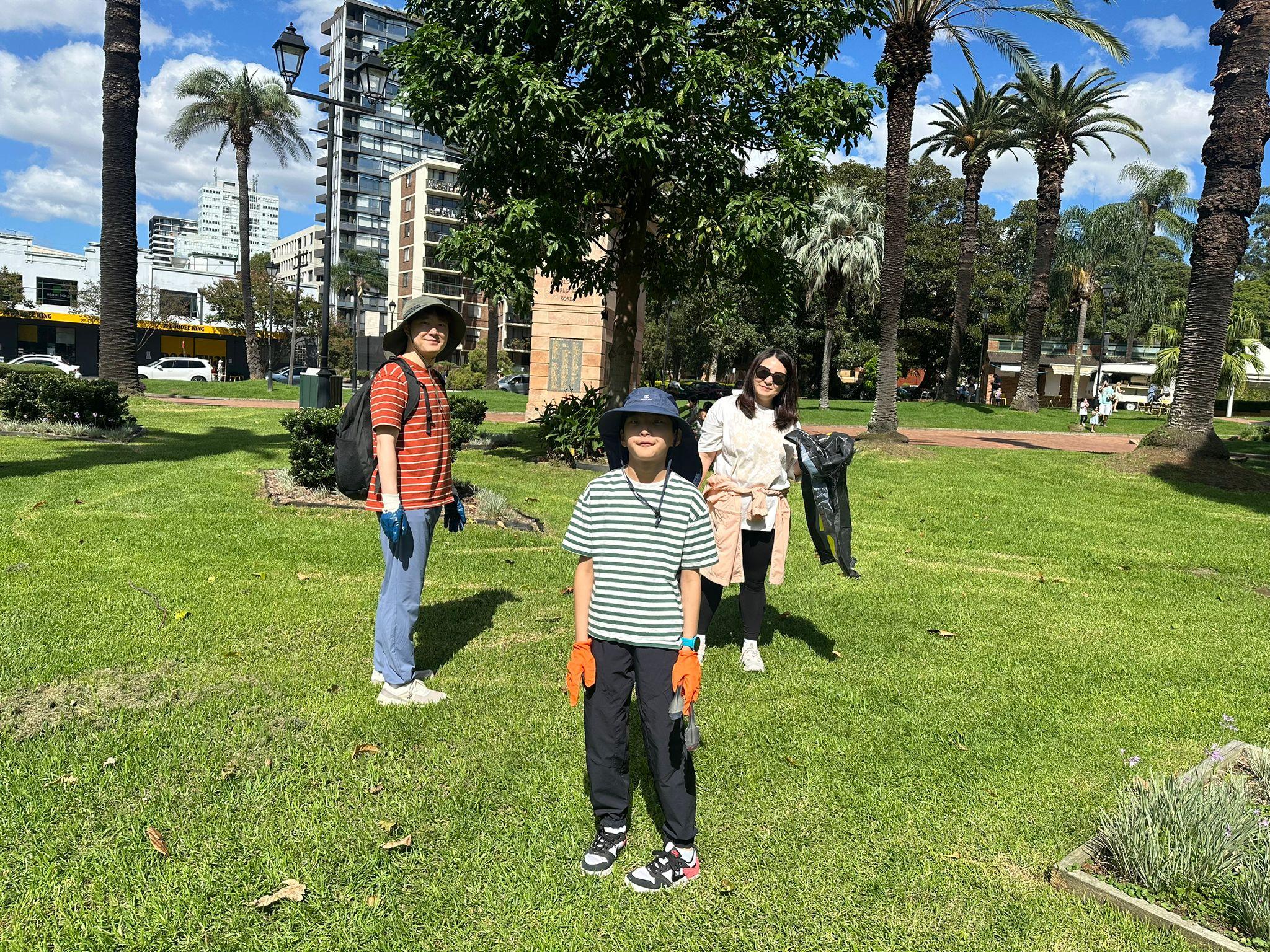 SMULC family members collecting rubbish in a Sydney park during a community clean-up