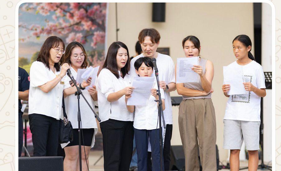 Multicultural choir performing at a community event with families singing together